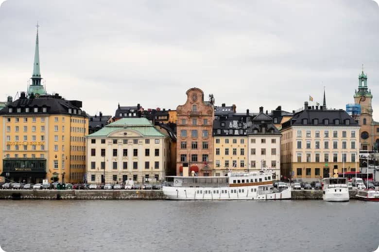 Margem ribeirinha de Gamla Stan, o centro histórico de Estocolmo, na Suécia, com barcos atracados ao longo do cais